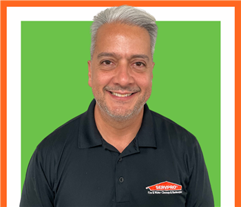 Javier, SERVPRO employee, cut out and set against a green backdrop