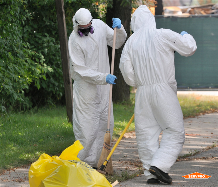 cleaners outside in white full body suits cleaning up hazardous waste near me in south orlando